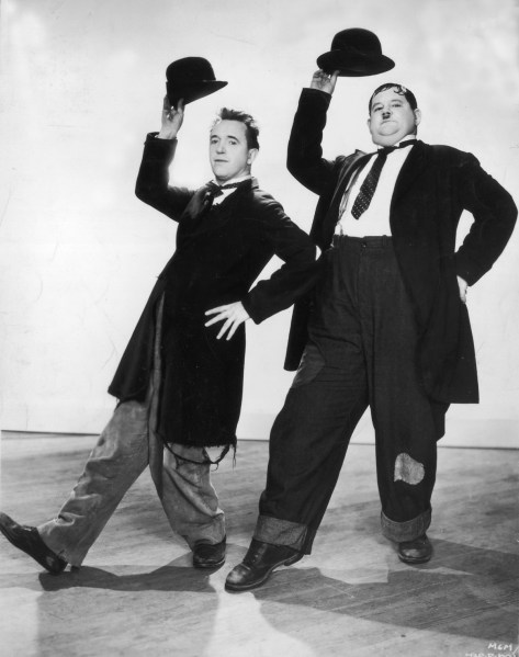 Stan Laurel (1890 - 1965) and Oliver Hardy (1892 - 1957) in a dance routine from the film 'Way Out West', directed by James Horne.   (Photo by Hulton Archive/Getty Images)
